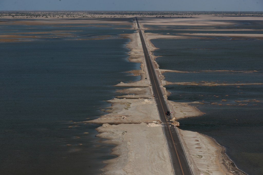 El Niño floodwater covers the Sechura desert in Peru on both sides of a highway, March 2023.